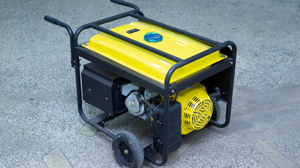 Portable generator with a bright yellow top and black frame, equipped with wheels and handles for mobility, positioned on a textured concrete surface.