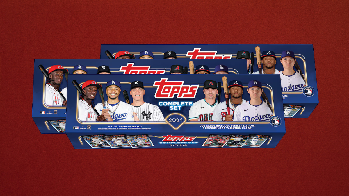 Three 2024 Topps Complete Set Baseball trading card boxes featuring MLB player images on the packaging, displayed against a bold red background.