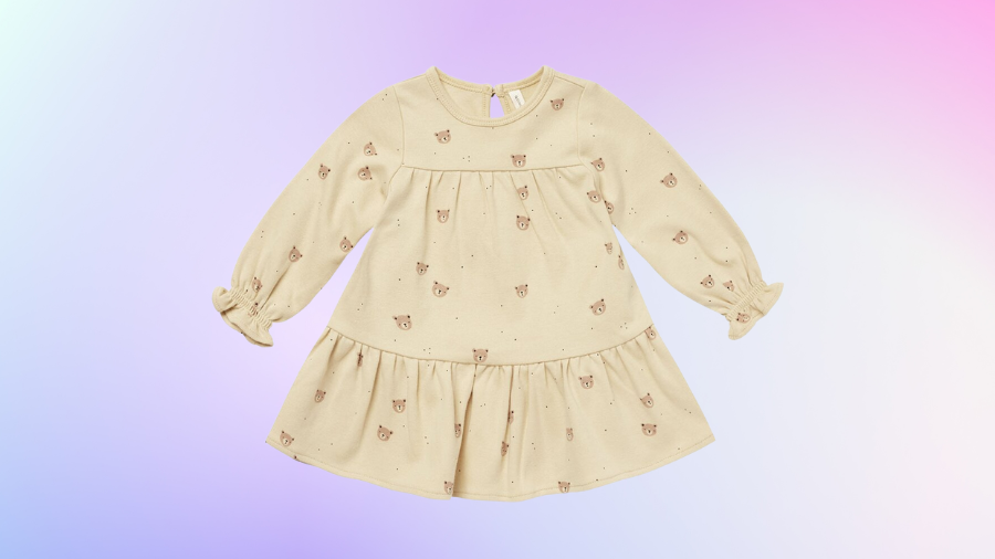 Beige long-sleeve dress with a bear print on a pastel gradient background.