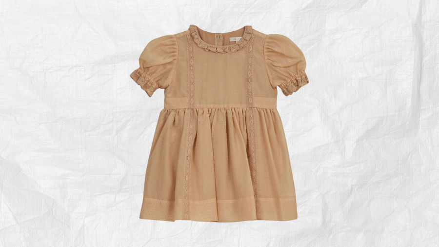 Light brown short-sleeve dress with ruffle details on a textured white background.